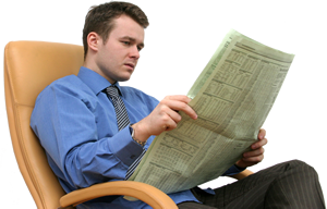 Photograph of a man reading a newspaper